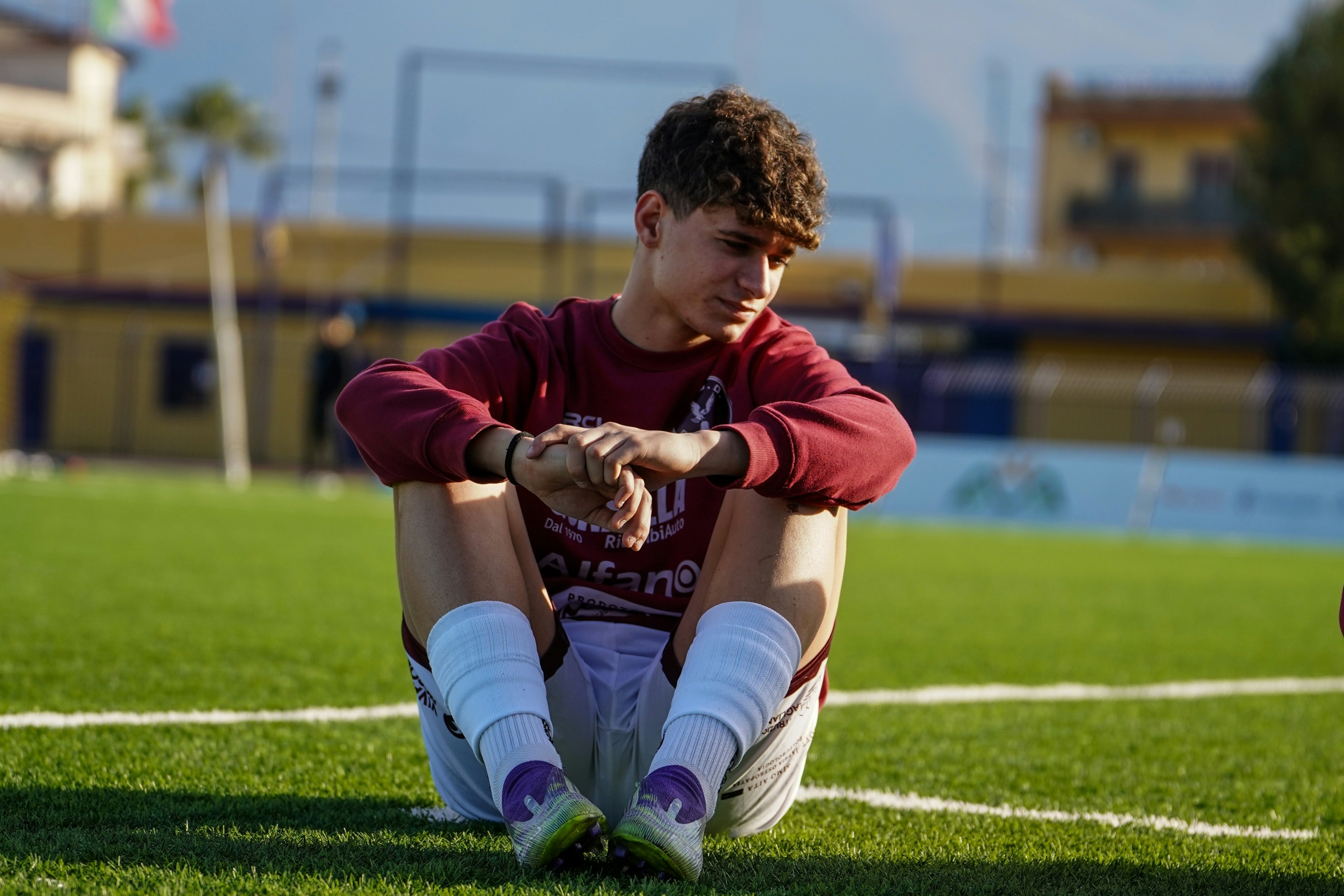 paediatric-mri-knee-injury Teenager sitting on a football pitch after a knee injury, a common reason for a child MRI